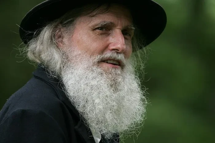 John Brown reenactor portrait with white beard and green background